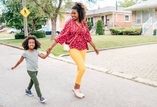 Black mom skiping with her daughter