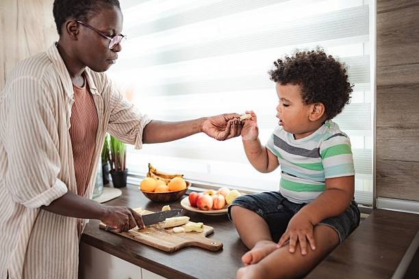 mother feeding toddlers