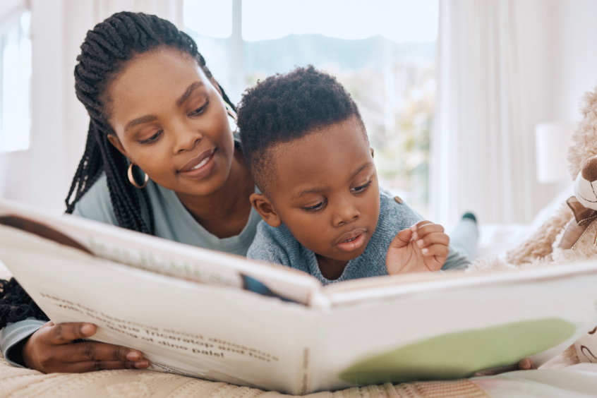 Mother reading a story book to his son