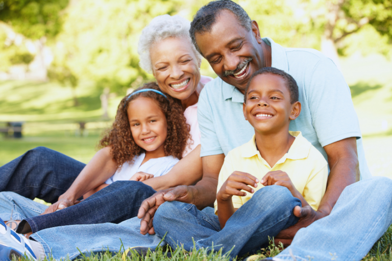 Grandparents with their grandchildren having a good time relaxing in the park